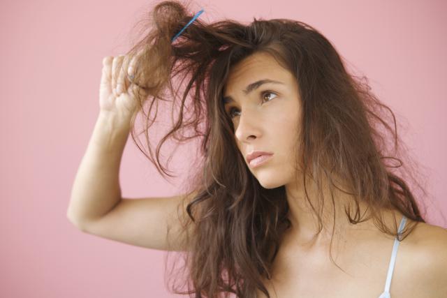 Woman combing knotted hair