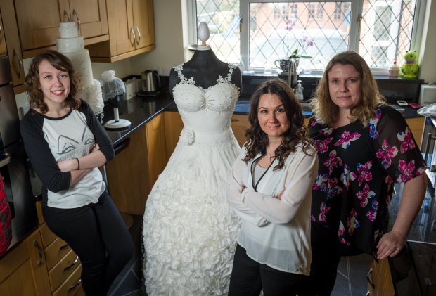 L-R Ilnka Rnic age 17,  Sylvia Elba age 38 and Yvette Marner age 43  with the life size wedding dress cake.  See Masons copy MNCAKE: A cake-maker has come up with a wedding day must-have after creating the world's first 'weddible' dress - made entirely out of CAKE. The tasty little number was fashioned by award-winning cake sculptor, Sylvia Elba, and weighs a whopping 70kg. The Weddible Dress bridal gown took a team of three more than 300 hours to complete, and stands at an impressive 170cm tall. Ms Elba worked on the cake with Yvette Marner, founder of Fun N Funky Cakes, and artist Ilinka Rnic.