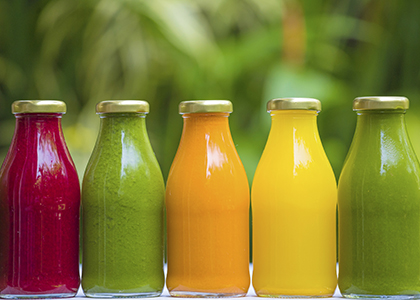 Organic cold-pressed raw vegetable juices in glass bottles