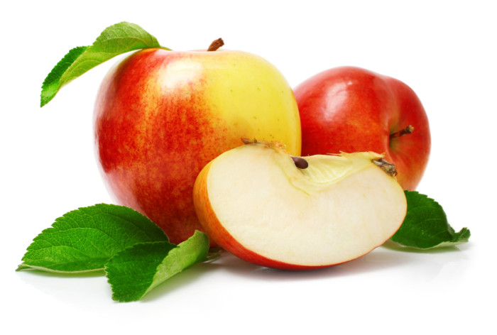 red apple fruits with cut and green leaves isolated on white background
