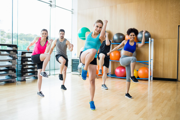 fitness class exercising in the studio at the gym